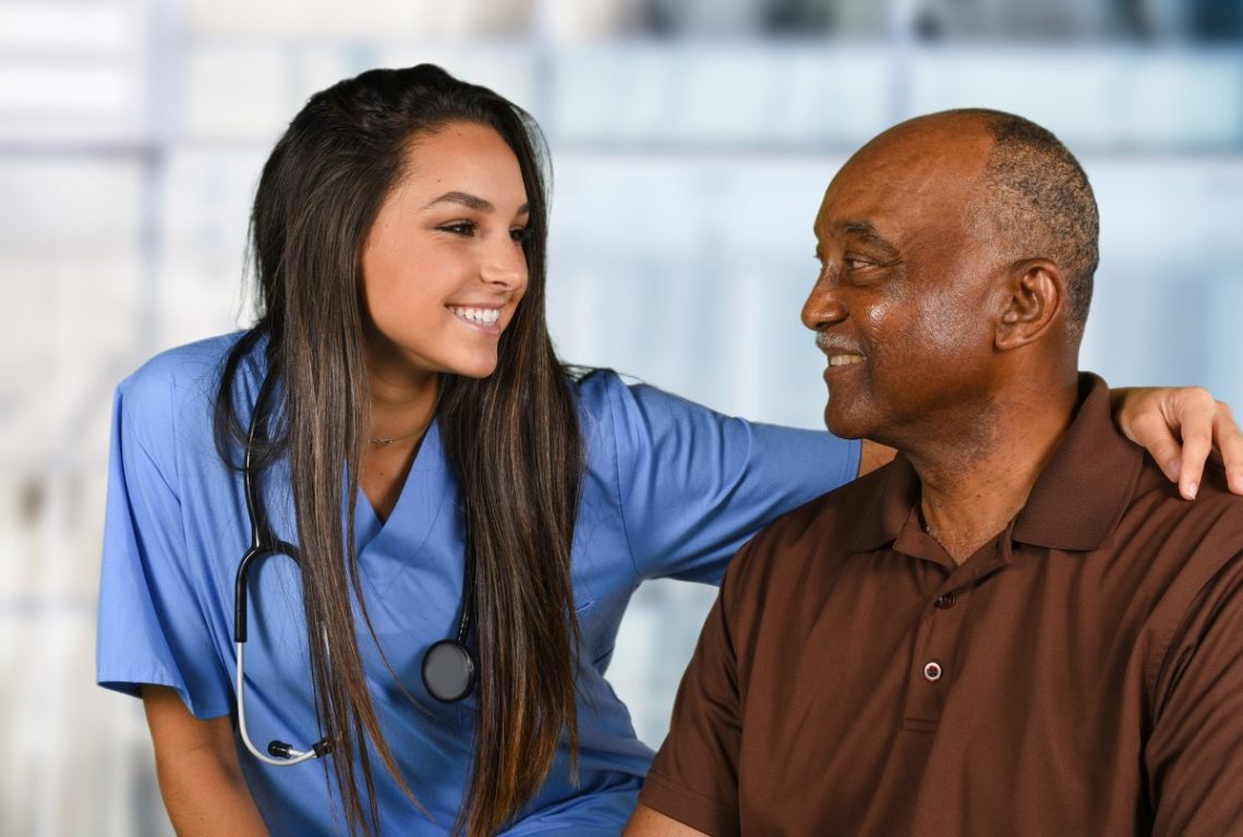 medicare - Health care worker helping an elderly patient